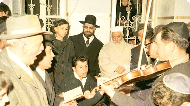 Rabbi Sharabi with a person playing the violin