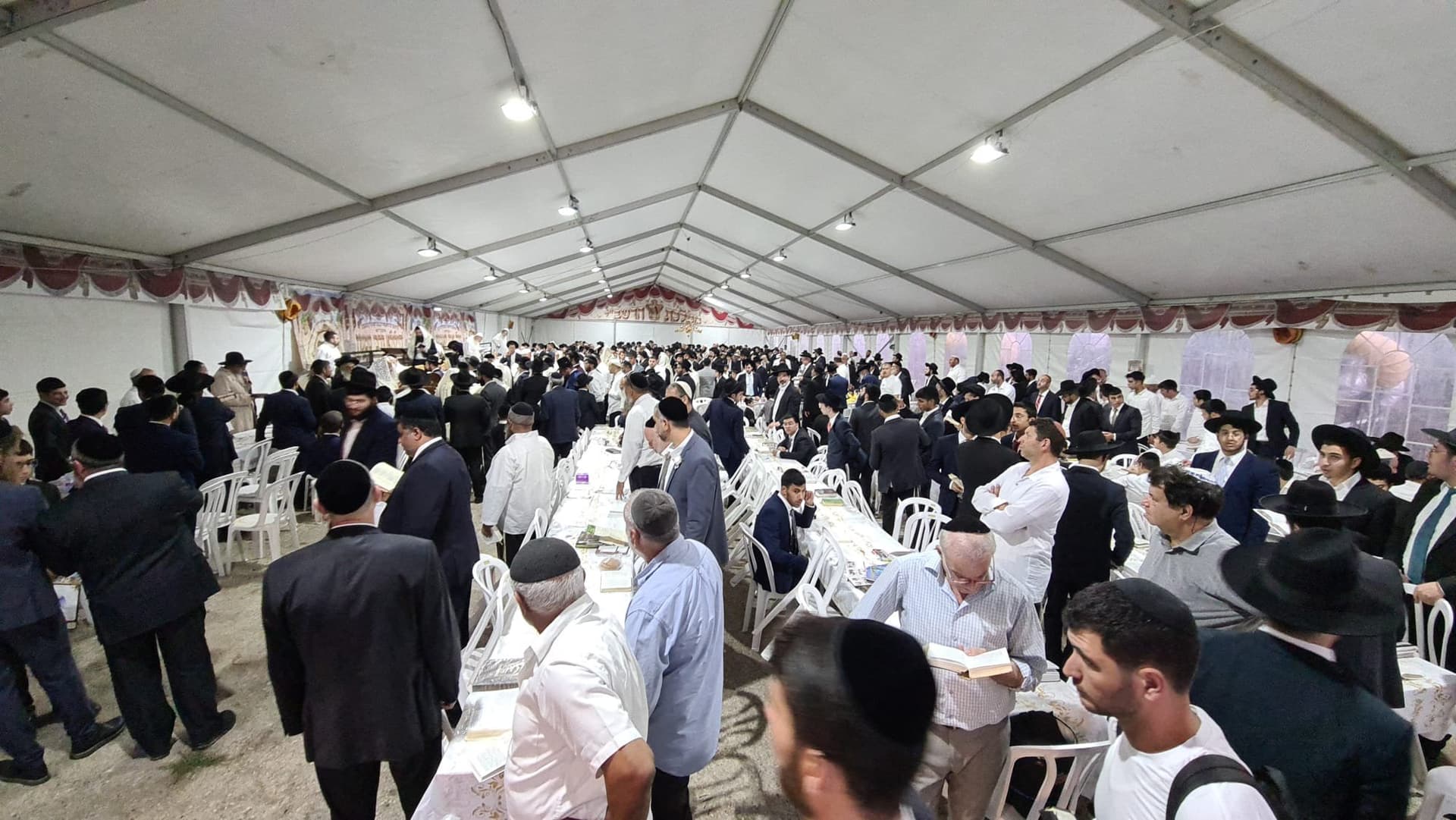 rabbi and congregation in the tent of Meron